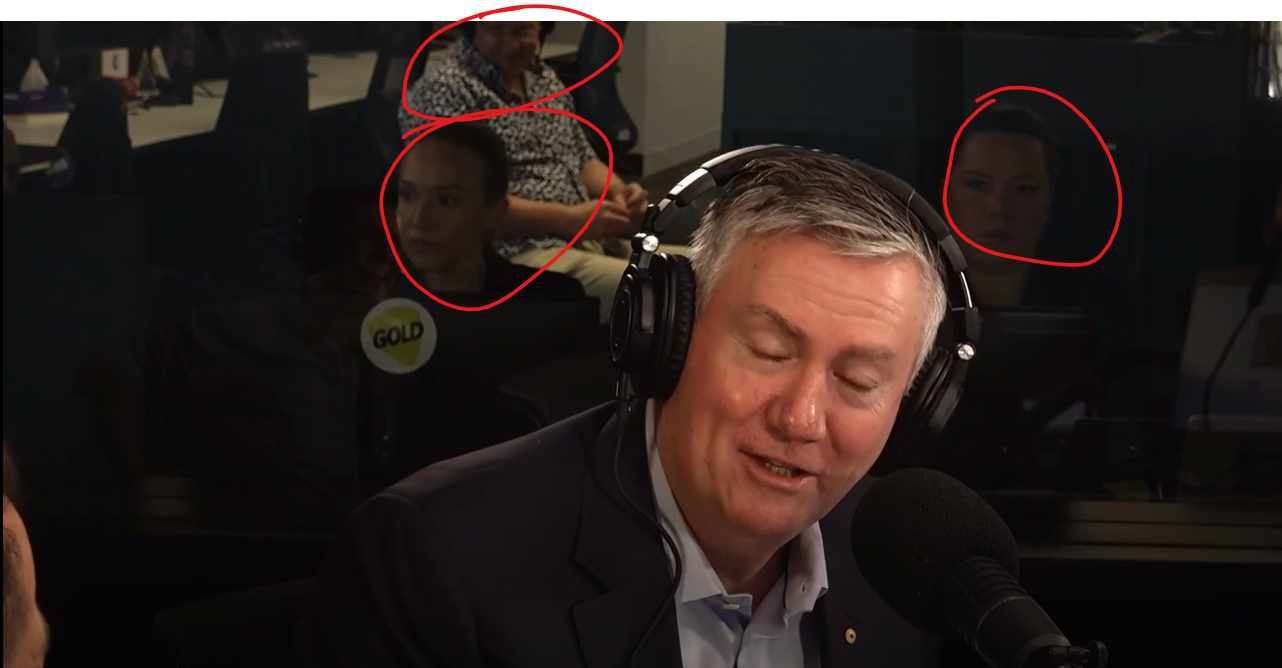 Glass reflection capturing crew and bystanders unintentionally